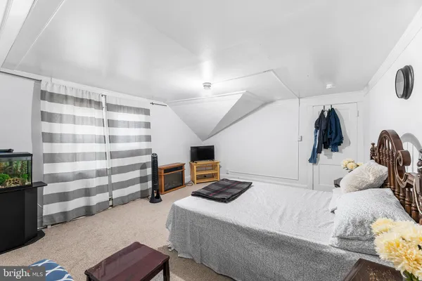 a bedroom with a bed and a book shelf