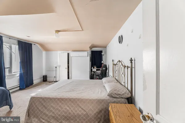 a bedroom with a bed and a mirror