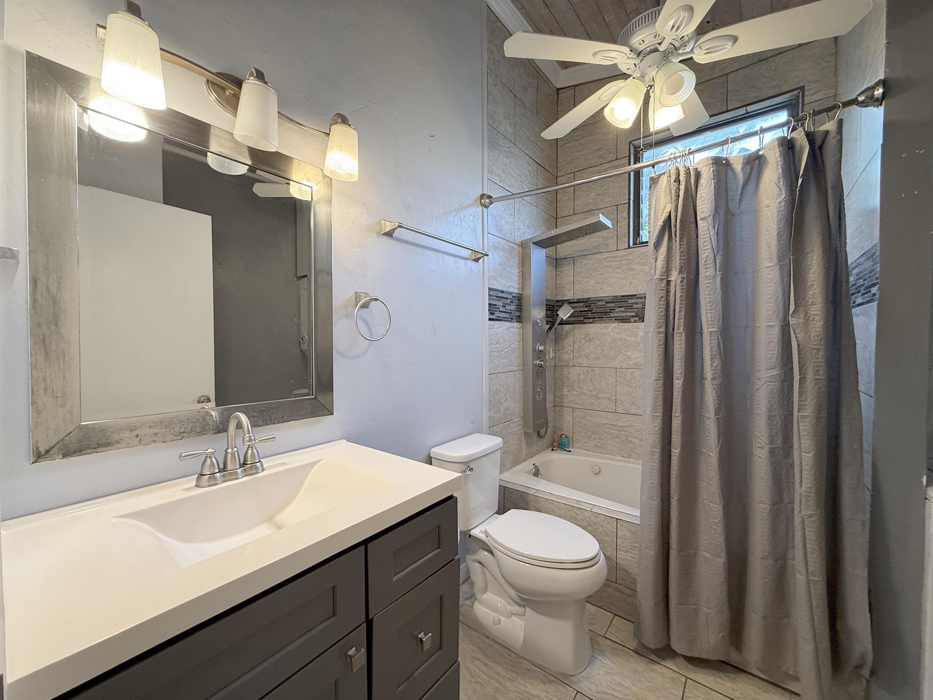 4435 Lower Honoapiilani Road, Unit 235 Lahaina, HI 96761 - Photo 14 of 21 a bathroom with a sink a toilet a mirror and shower