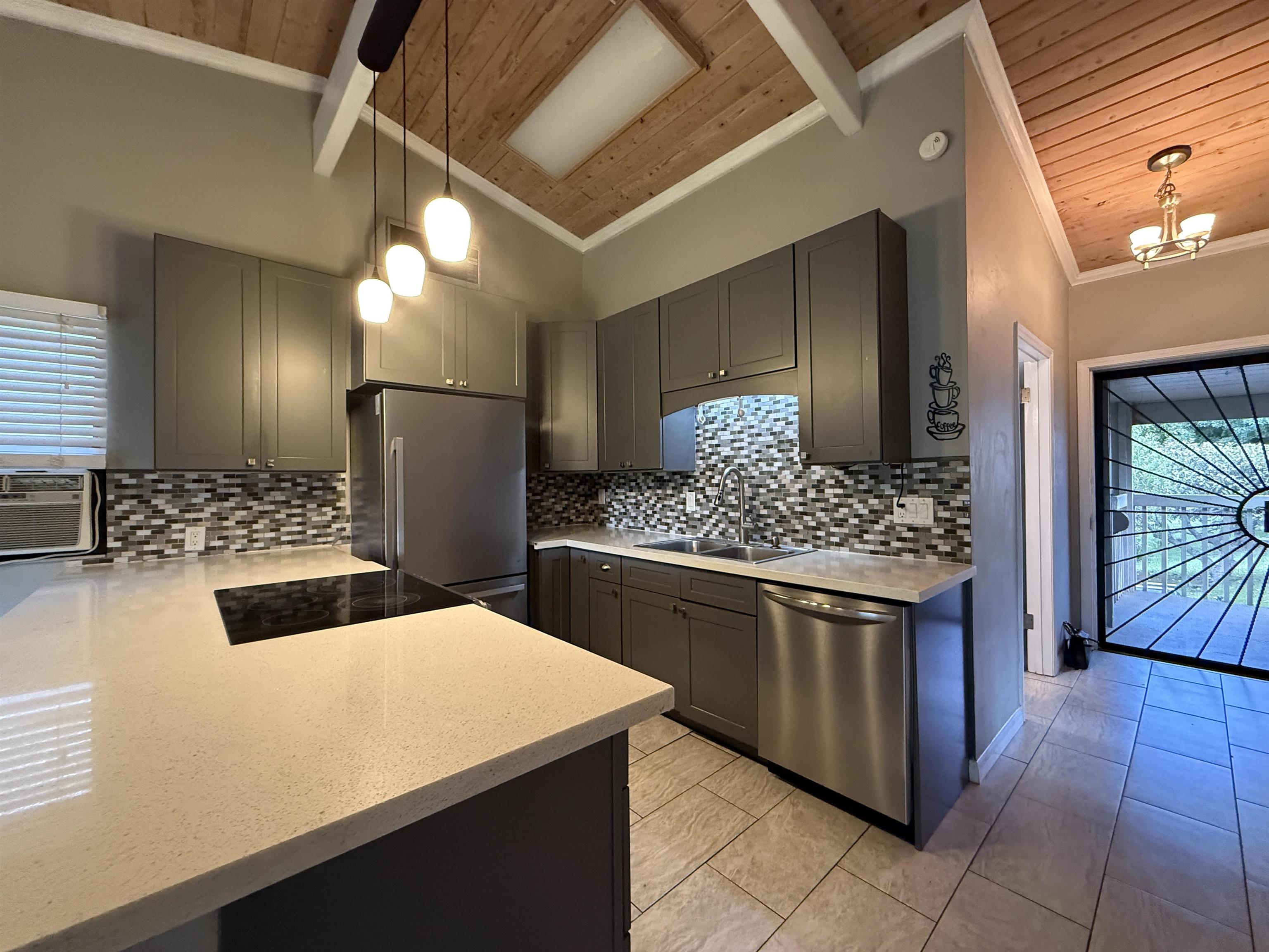 4435 Lower Honoapiilani Road, Unit 235 Lahaina, HI 96761 - Photo 3 of 21 a kitchen with stainless steel appliances kitchen island granite countertop a sink and cabinets