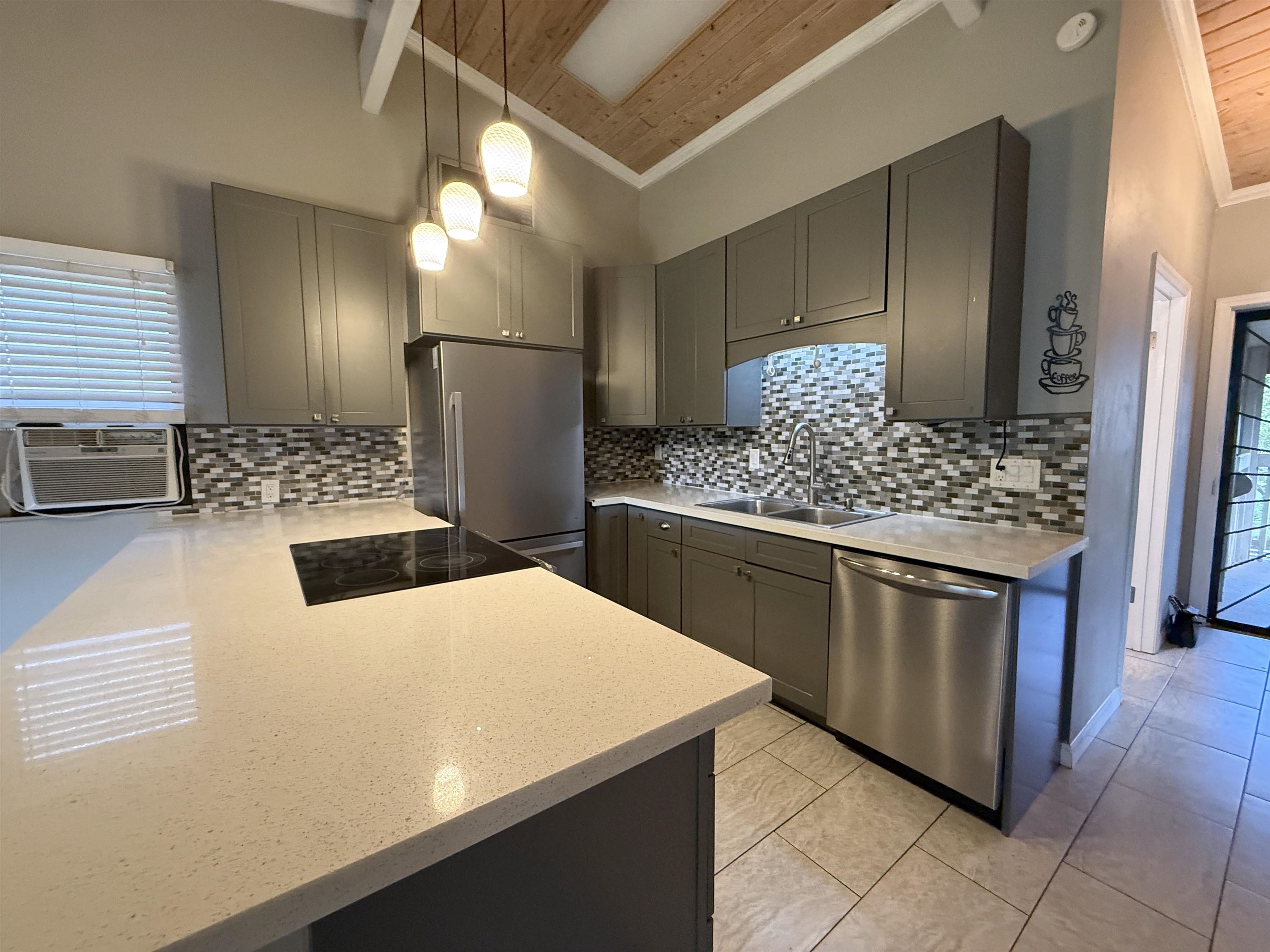 4435 Lower Honoapiilani Road, Unit 235 Lahaina, HI 96761 - Photo 5 of 21 a kitchen with stainless steel appliances kitchen island granite countertop a sink stove and refrigerator