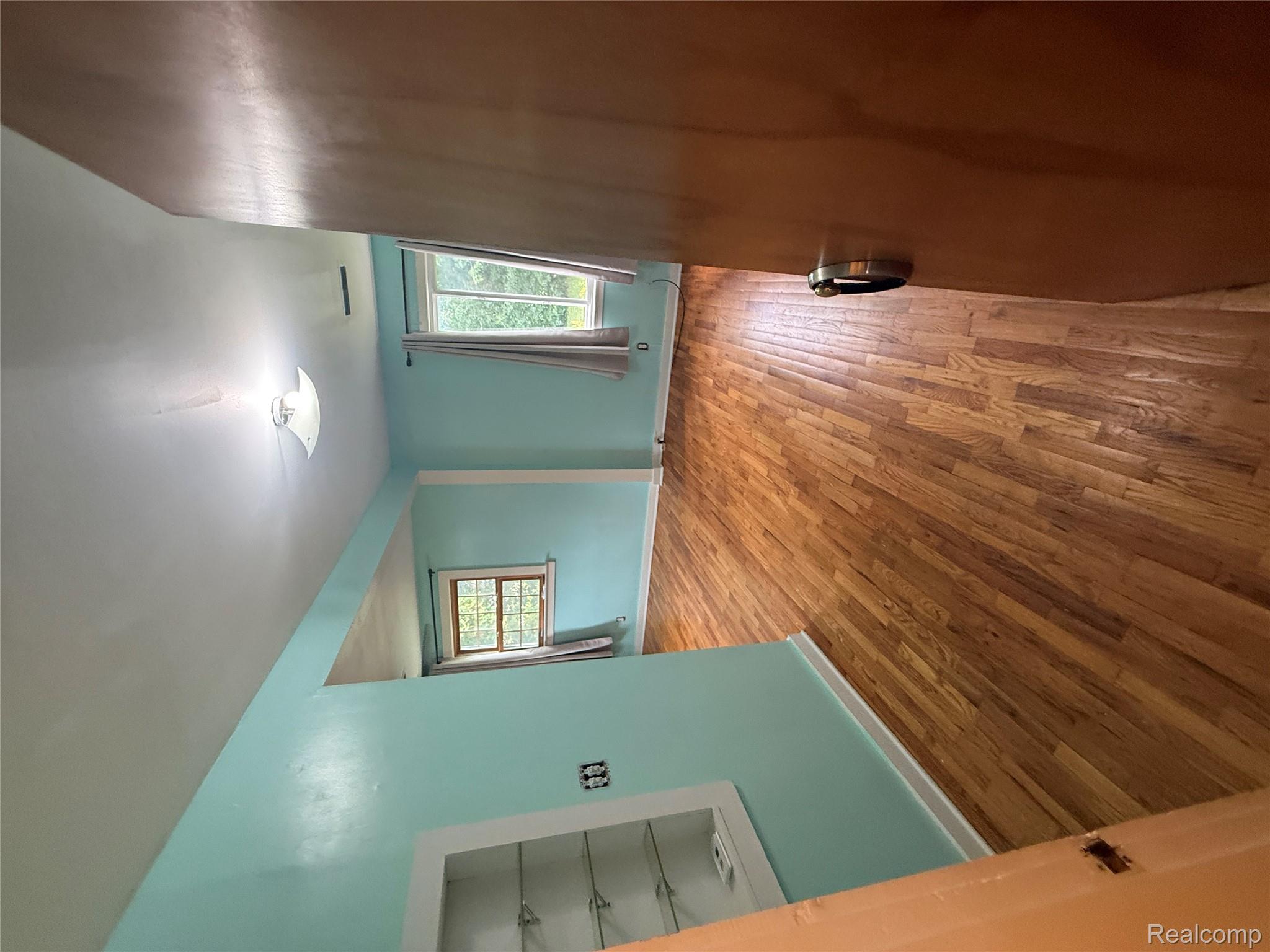 3176 East Fisher Road Bay City, MI 48706 - Photo 9 of 25 Unfurnished room with wood finished floors and baseboards