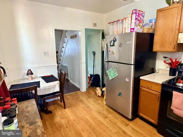 a bed room with a bed and a refrigerator