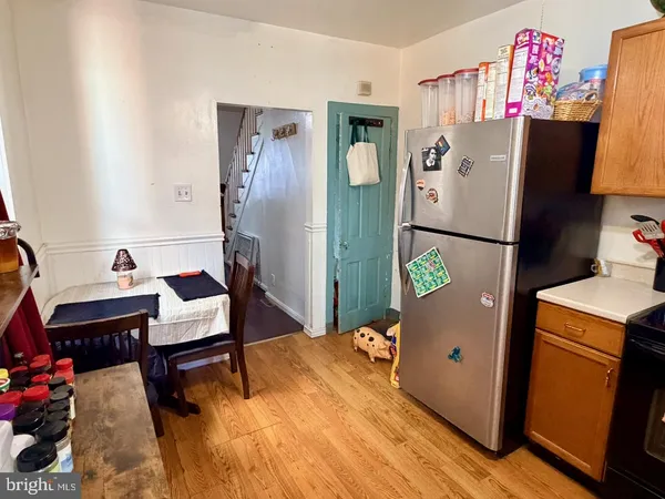 a room with furniture a refrigerator and a table