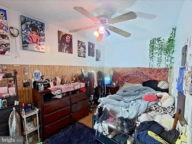 a bedroom with furniture and a chandelier