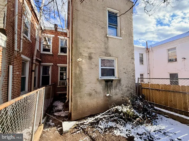 a view of a house with a wooden fence