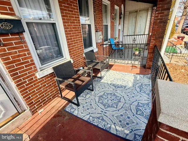 a balcony with chairs and wooden floor