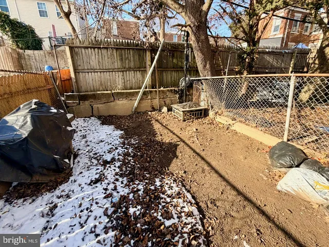 a view of roof deck with wooden floor and fence
