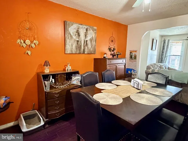 a open dining room with furniture and wooden floor
