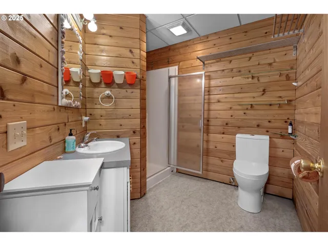 a bathroom with a toilet and a shower