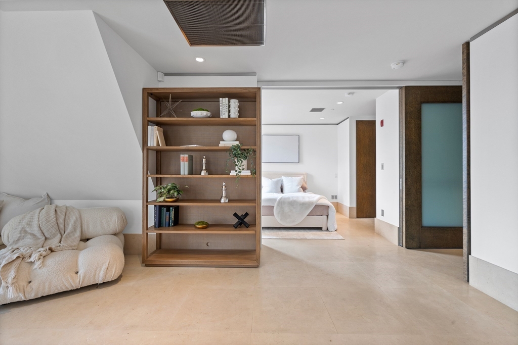 314 Commonwealth Avenue, Unit PH Boston, MA 02115 - Photo 19 of 41 a living room with furniture and white walls