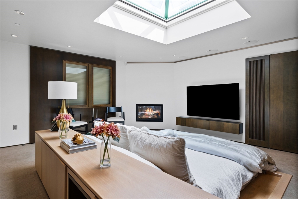 314 Commonwealth Avenue, Unit PH Boston, MA 02115 - Photo 28 of 41 a living room with furniture and a flat screen tv