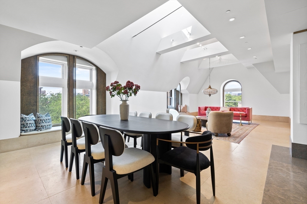 314 Commonwealth Avenue, Unit PH Boston, MA 02115 - Photo 6 of 41 a view of a dining room with furniture and wooden floor