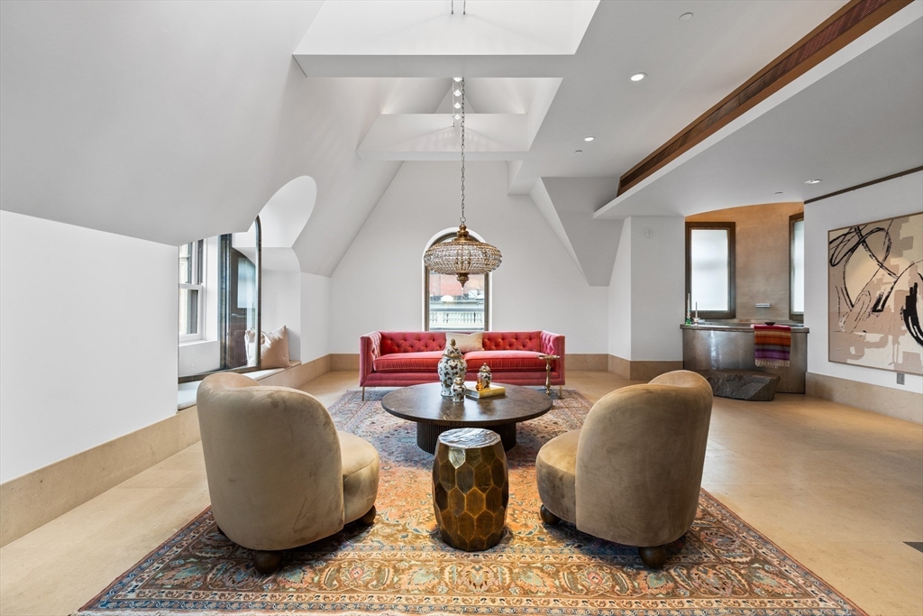 314 Commonwealth Avenue, Unit PH Boston, MA 02115 - Photo 9 of 41 a dining room with furniture a chandelier and wooden floor