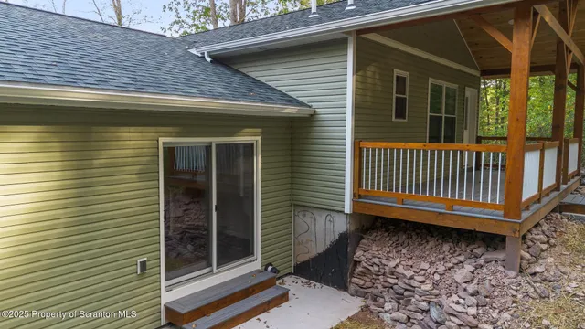a view of a house with a small yard and wooden floor and fence