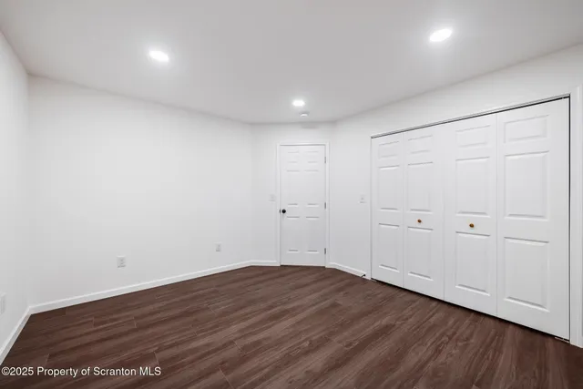 a view of room with wooden floor