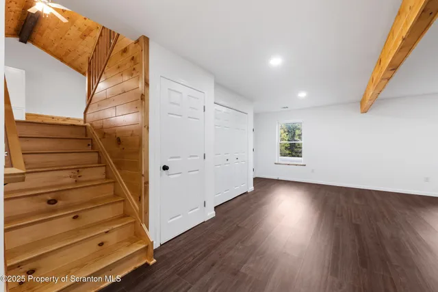 a view of an entryway with wooden floor