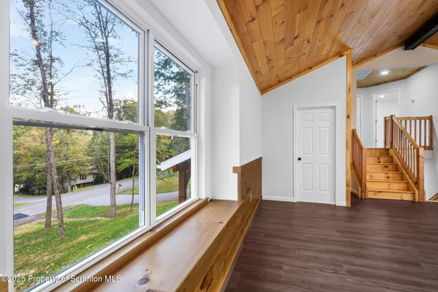 a view of a room with wooden floor and stairs