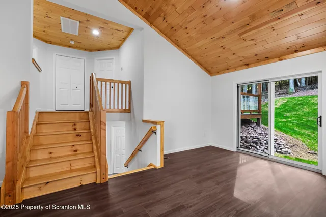 a view of an entryway with wooden floor