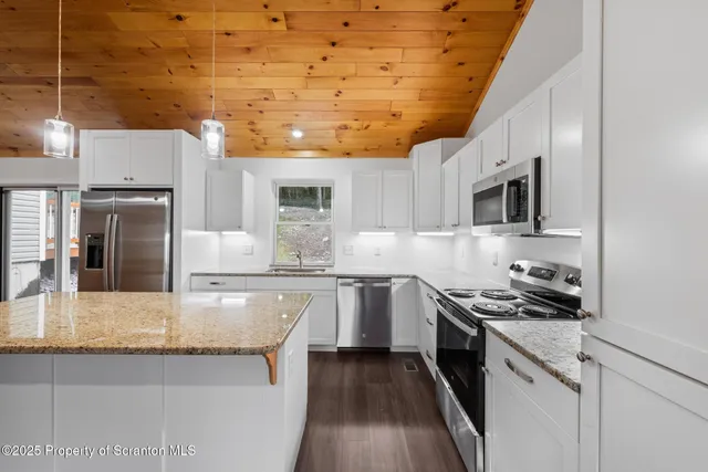 a kitchen with stainless steel appliances a sink stove and refrigerator