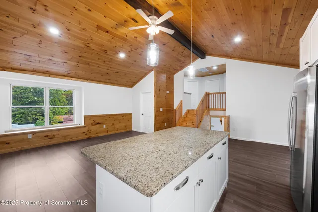 a kitchen with a sink a counter top space and stainless steel appliances