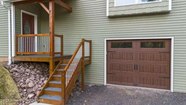 a view of a house with a wooden deck
