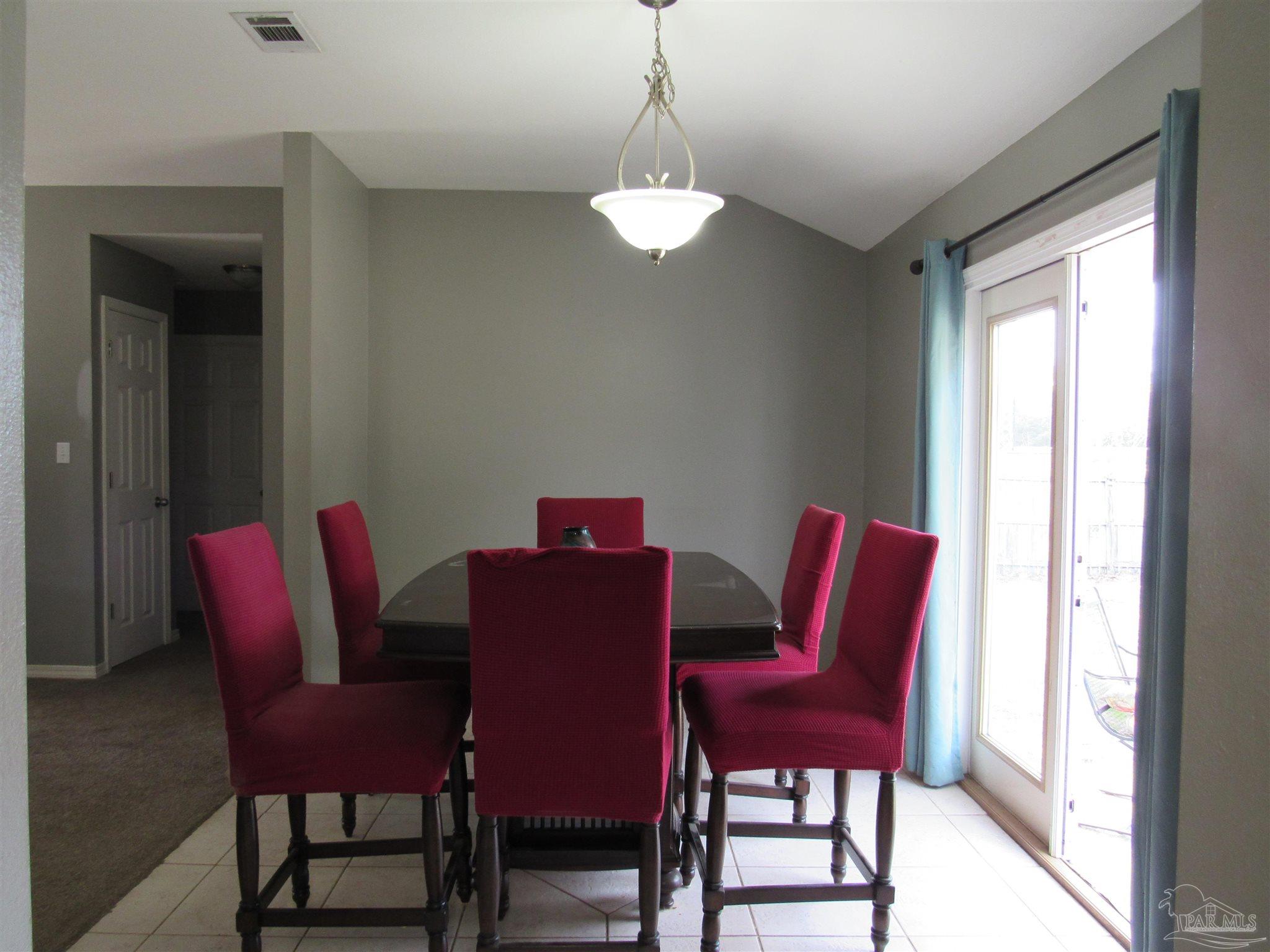 3661 Burton Circle Navarre, FL 32566 - Photo 4 of 17 a view of a dining room with furniture window and wooden floor