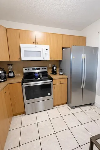 a kitchen with cabinets a sink and a stove top oven