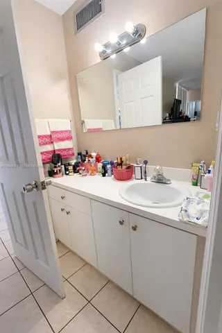 a bathroom with a sink vanity and mirror