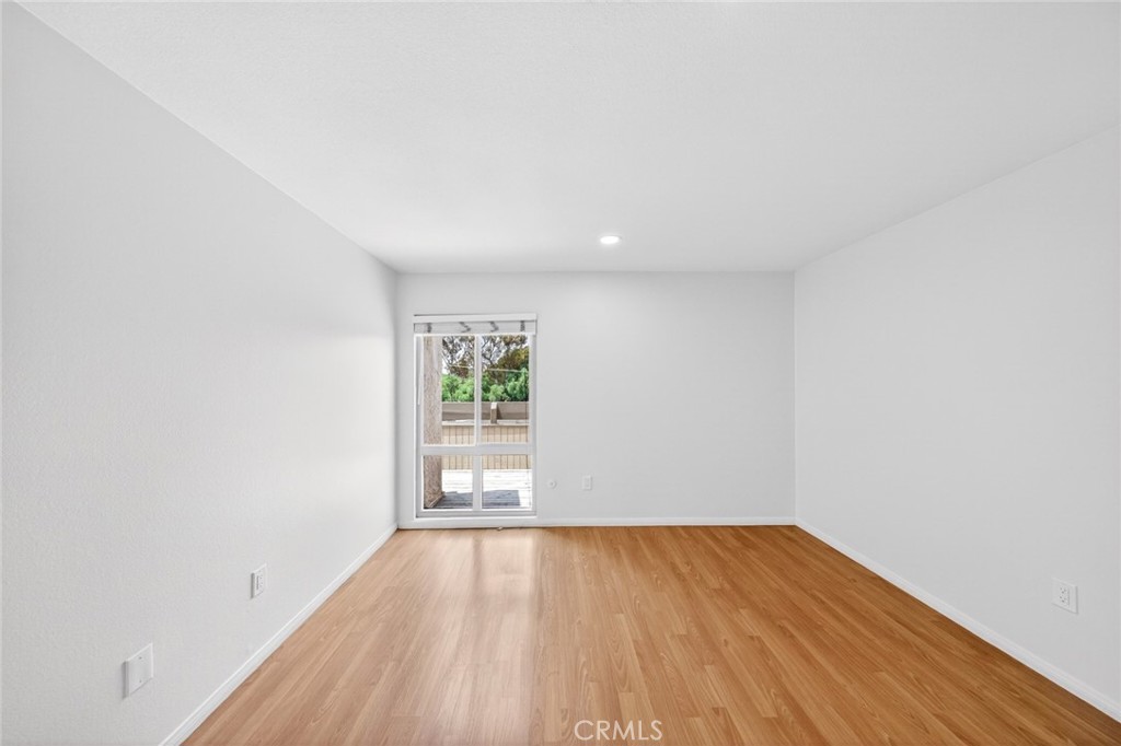 3054 Associated, Unit 26 Fullerton, CA 92835 - Photo 13 of 27 a view of an empty room and wooden floor