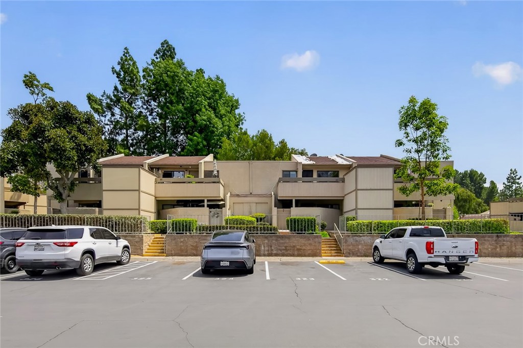 3054 Associated, Unit 26 Fullerton, CA 92835 - Photo 18 of 27 a car parked in front of a house