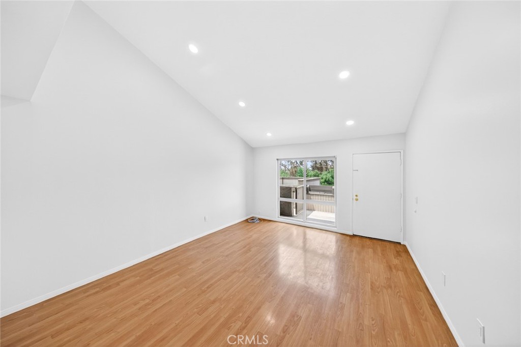3054 Associated, Unit 26 Fullerton, CA 92835 - Photo 9 of 27 a view of an empty room with wooden floor and a window