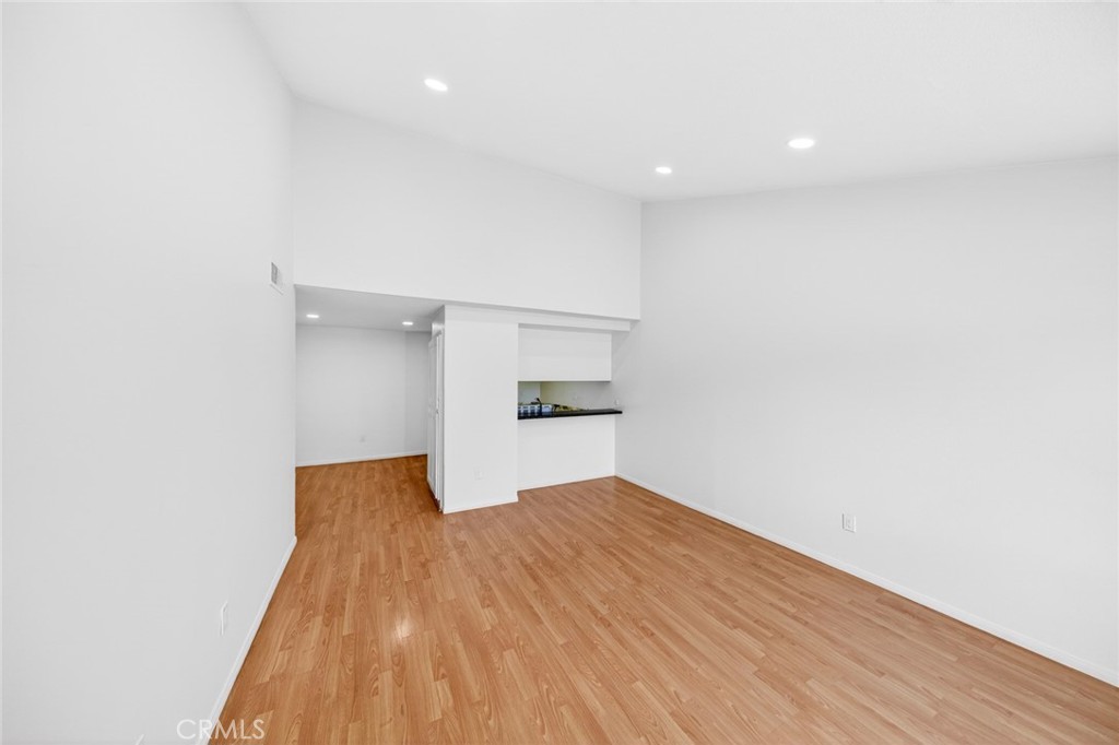 3054 Associated, Unit 26 Fullerton, CA 92835 - Photo 10 of 27 a view of a big room with wooden floor and a kitchen