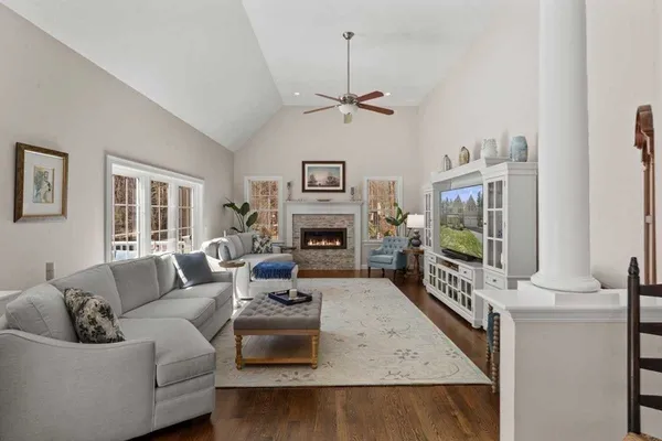a bedroom with a bed chandelier and a window