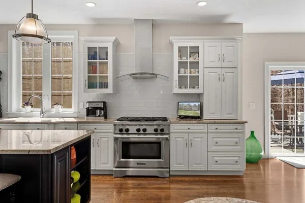 a living room with furniture a flat screen tv and a floor to ceiling window