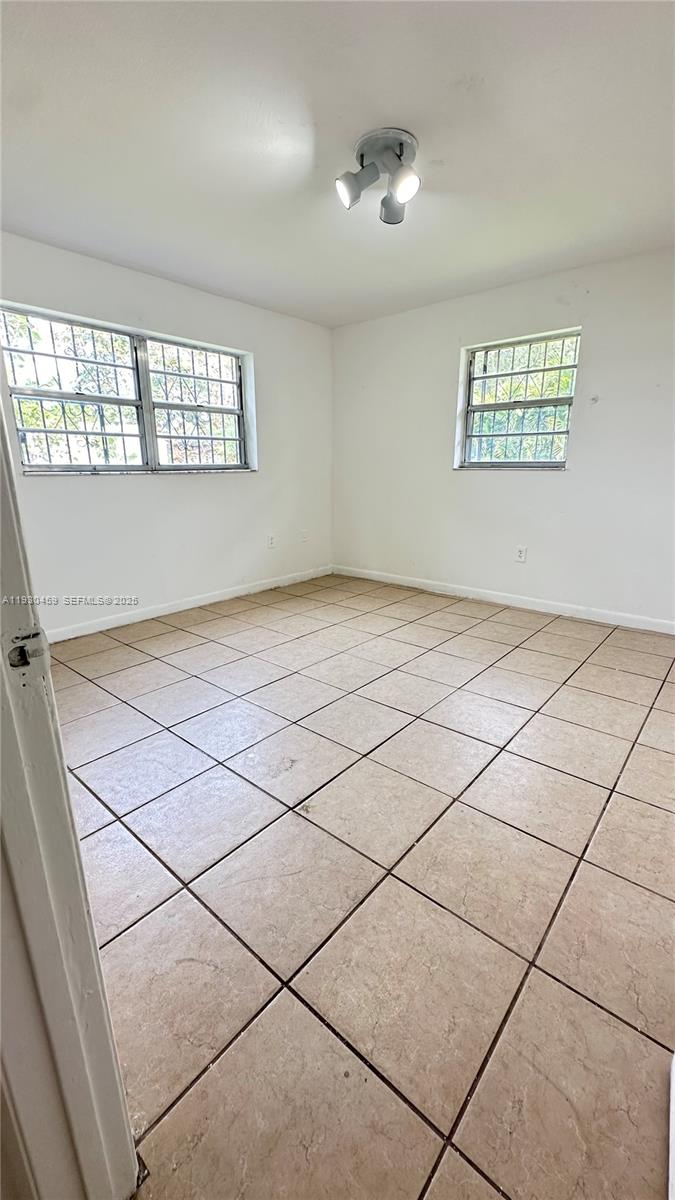 2175 Northwest 104th Street, Unit 2 Miami, FL 33147 - Photo 12 of 13 a view of an empty room and window