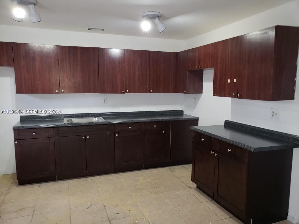 2175 Northwest 104th Street, Unit 2 Miami, FL 33147 - Photo 3 of 13 a kitchen with a cabinets and a sink