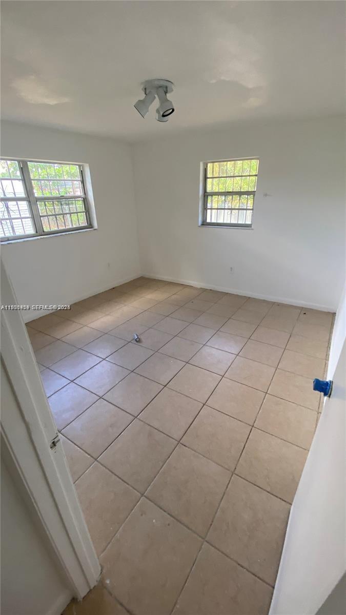 2175 Northwest 104th Street, Unit 2 Miami, FL 33147 - Photo 6 of 13 a view of an empty room and window