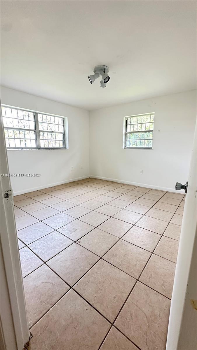 2175 Northwest 104th Street, Unit 2 Miami, FL 33147 - Photo 7 of 13 a view of an empty room and window