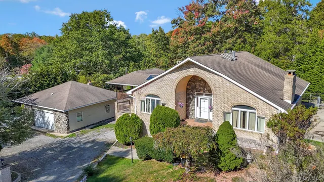 a aerial view of a house with a yard and potted plants