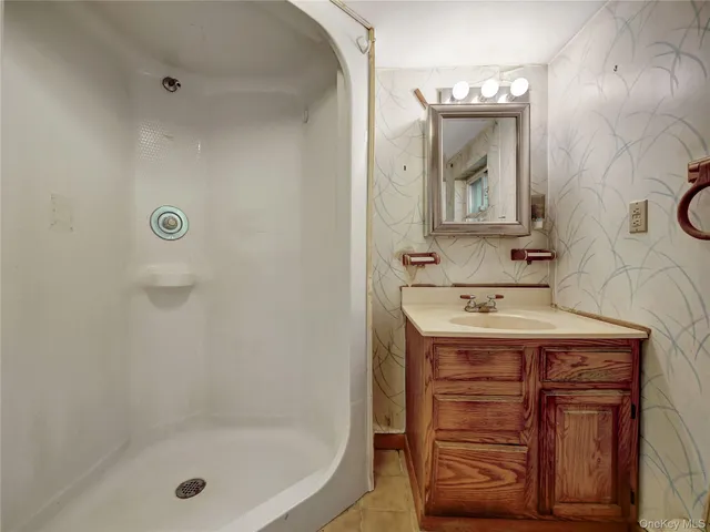 a bathroom with a sink and mirror