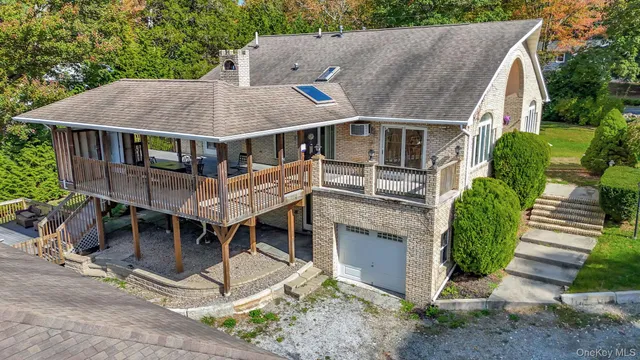 a aerial view of a house with a yard and potted plants
