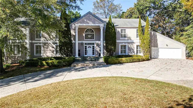 a front view of a house with a garden