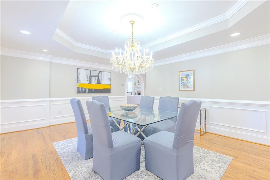 7680 Jett Ferry Road Atlanta, GA 30350 - Photo 13 of 74 a view of a dining room with furniture and chandelier
