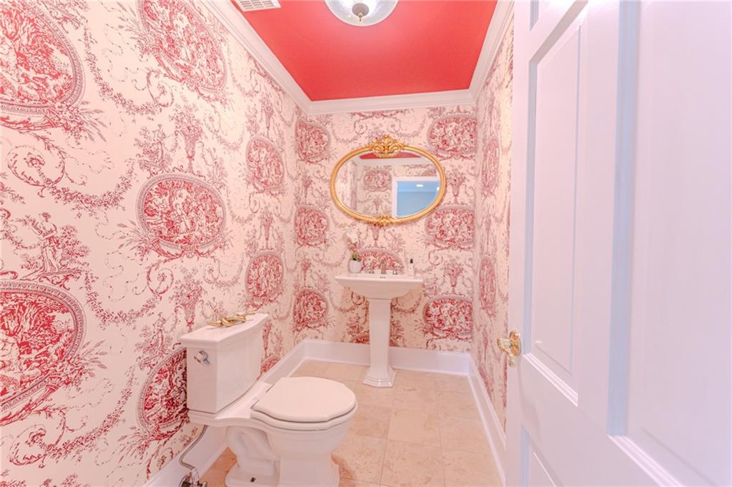 7680 Jett Ferry Road Atlanta, GA 30350 - Photo 18 of 74 a bathroom with a granite countertop toilet and a sink