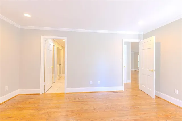 a view of an entryway wooden floor and chandelier