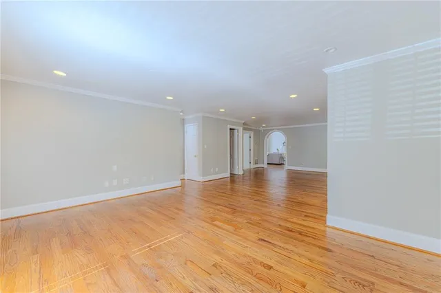 a spacious bathroom with a granite countertop sink mirror and a bathtub