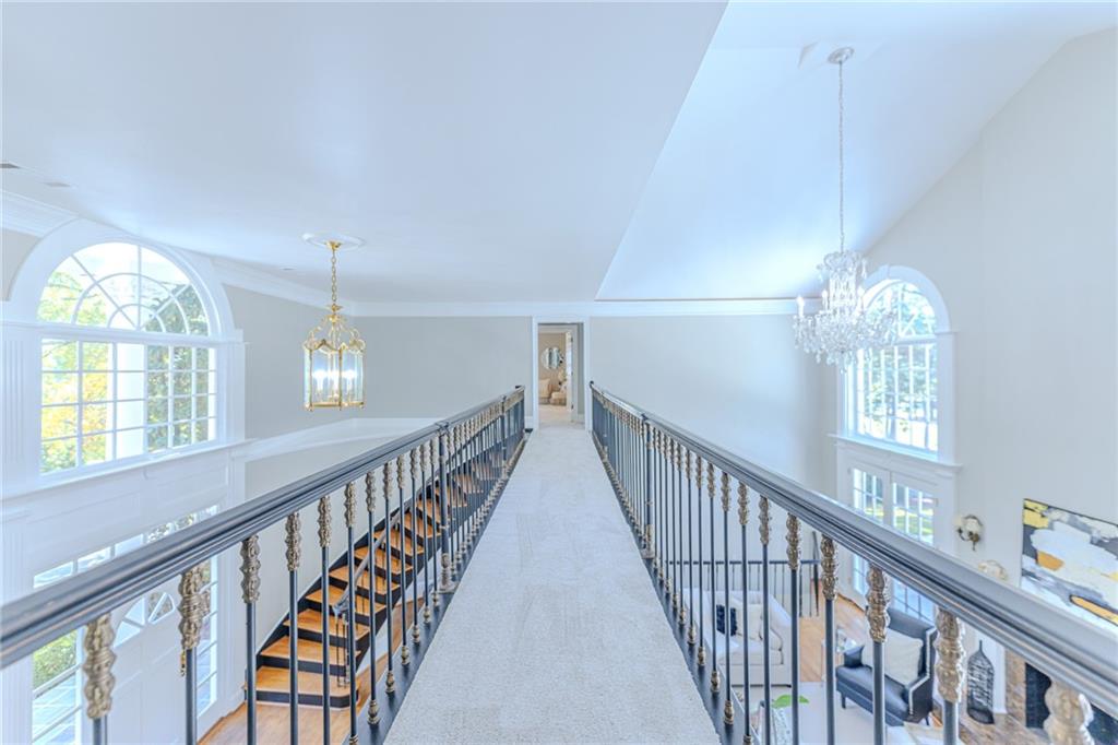 7680 Jett Ferry Road Atlanta, GA 30350 - Photo 25 of 74 a view of an entryway wooden floor and chandelier