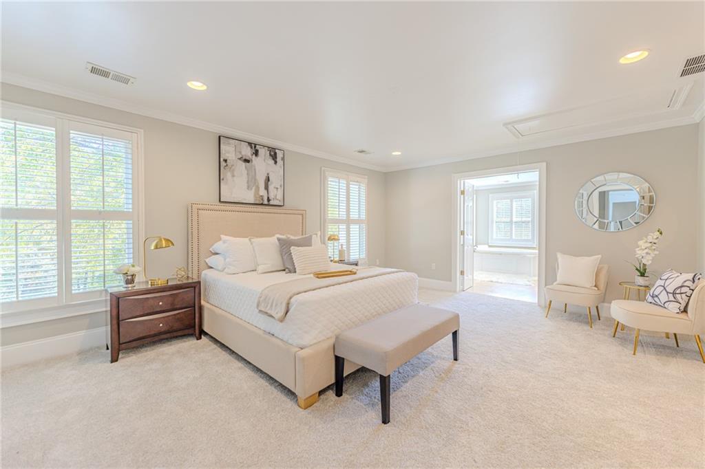 7680 Jett Ferry Road Atlanta, GA 30350 - Photo 26 of 74 a spacious bedroom with a large bed and a couch