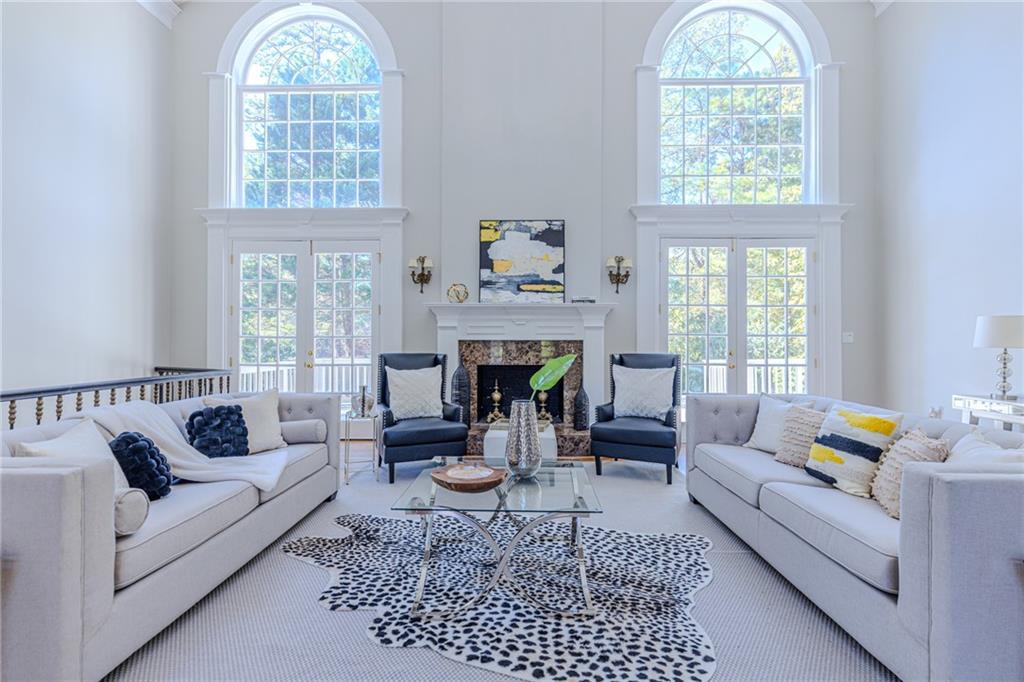 7680 Jett Ferry Road Atlanta, GA 30350 - Photo 3 of 74 a living room with furniture a fireplace and a large window